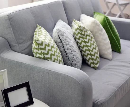 Gray sofa with green and white pillows