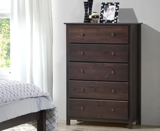 Dark wood dresser with five drawers in bedroom.