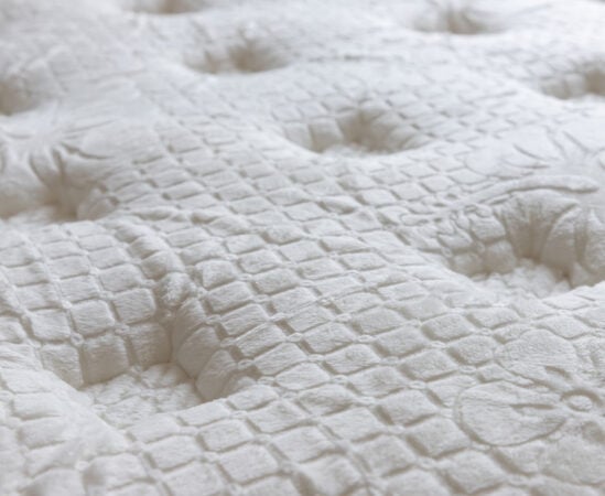 Close-up of textured white mattress surface